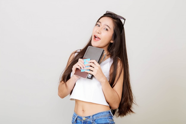 Young pretty Asian woman holding wallet with credit card