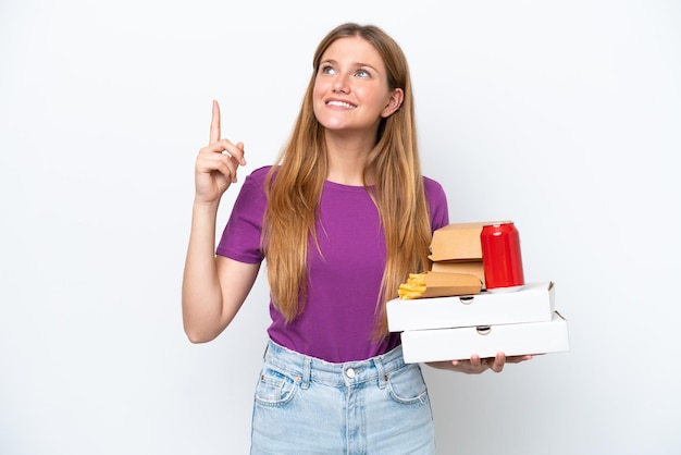 Young pretty blonde woman holding fast food isolated on white background pointing up a great idea