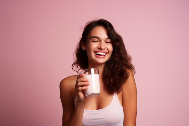 Young pretty brunette girl over isolated colorful background with strawberry milkshake