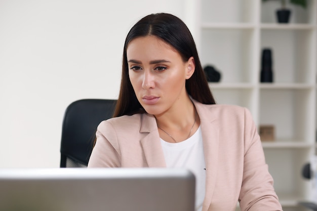 Young pretty business woman with notebook in the office