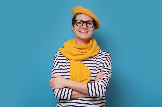 Young pretty caucasian woman smiling at camera Studio shot on blue wall