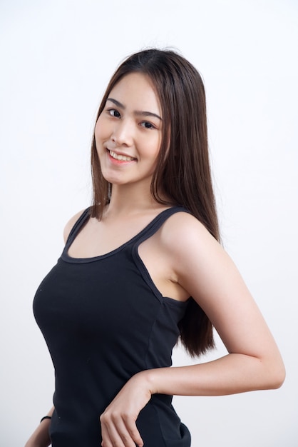 Young pretty and cute Asian girl in black lady vest standing with smile 