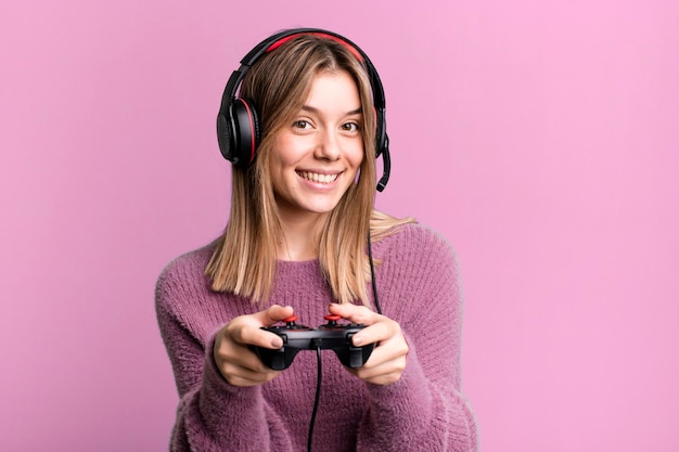 Young pretty gamer woman with headset and a controller