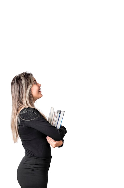 Young pretty girl confident happy ready to back to school With books on arms Isolated on white background Looking up copy space