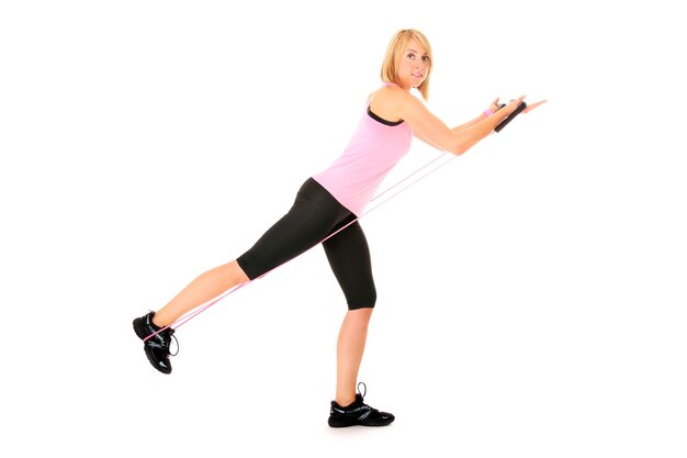 a young pretty girl exercising with a body trimmer over white background