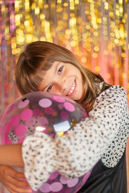 Young pretty girl at festive party with balloons