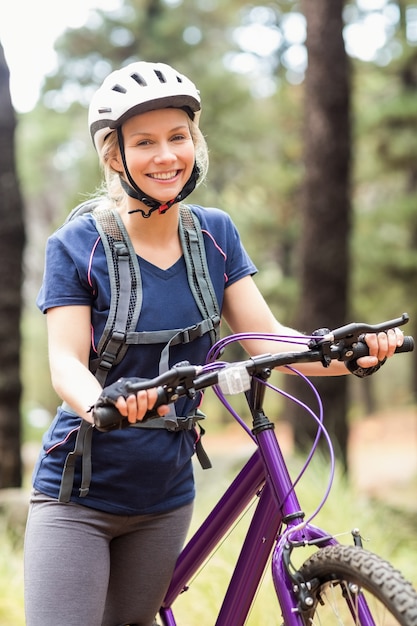 Young pretty happy biker looking at camera