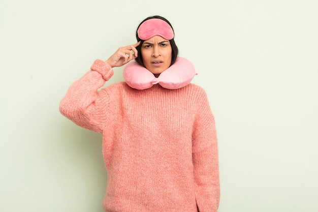 Young pretty hispanic woman feeling confused and puzzled showing you are insane plane passenger concept