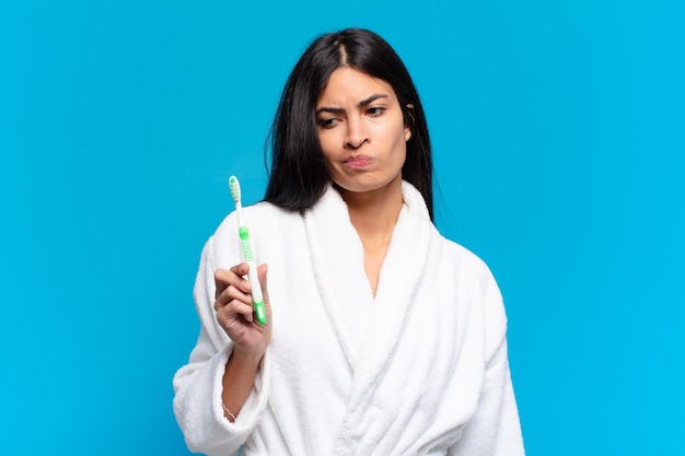 Young pretty hispanic woman. with a toothbrush