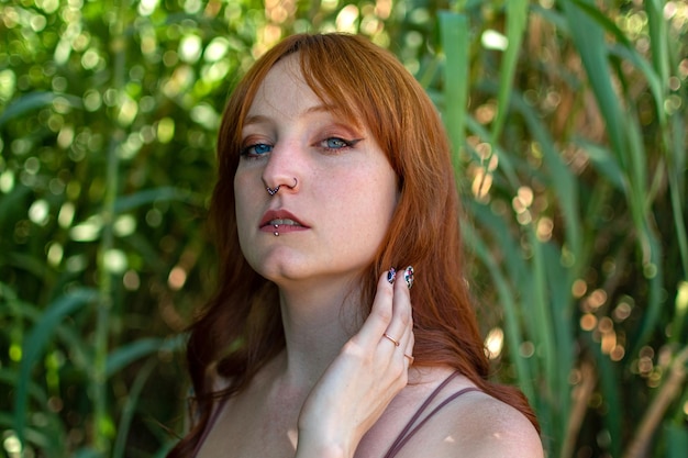 Young pretty redhead woman at outdoors With serious expression