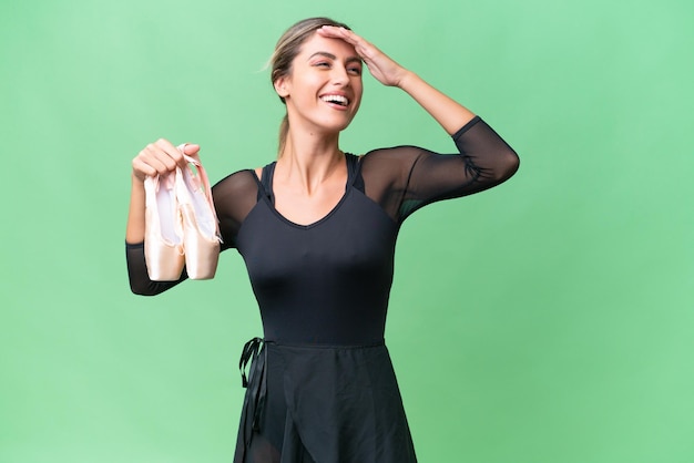 Young pretty Uruguayan woman practicing ballet over isolated background smiling a lot