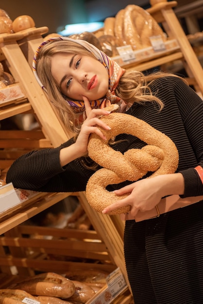 The young pretty woman in the bread depatment at the supermarket