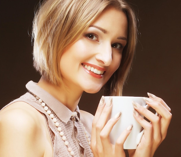 Young pretty woman drinking coffee