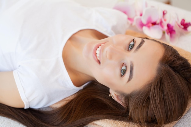 Young pretty woman enjoying face massage procedure