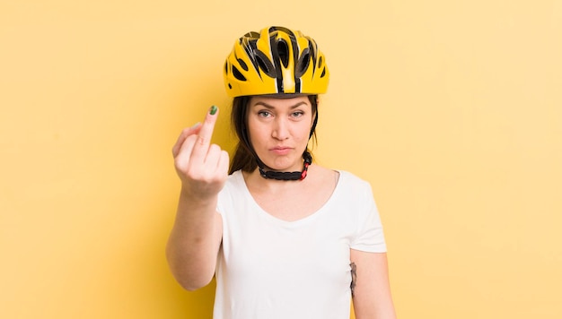 Young pretty woman feeling angry annoyed rebellious and aggressive bike helmet concept