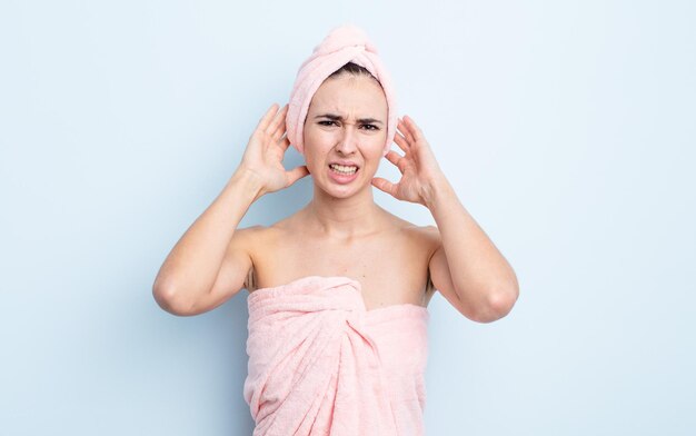 Young pretty woman feeling stressed, anxious or scared, with hands on head. beauty and shower concept