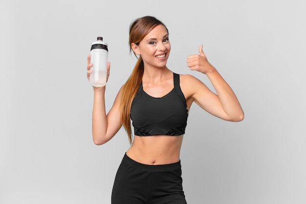 Young pretty woman fitness concept and drinking water