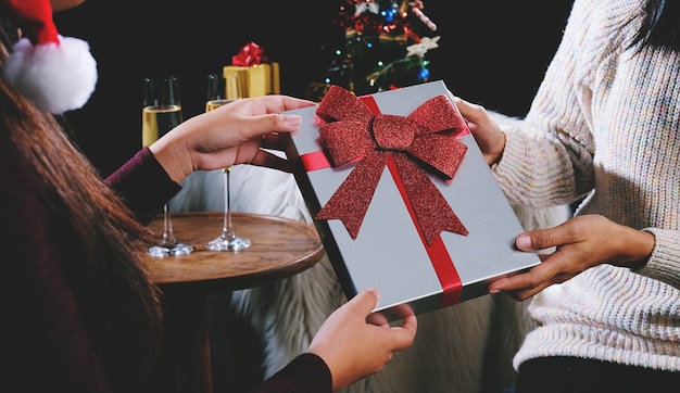 Young pretty woman giving a present to friend