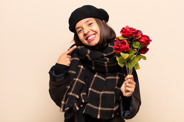 Young pretty woman holding a bouquet of roses