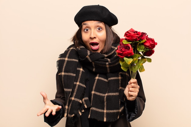 Young pretty woman holding a bouquet of roses