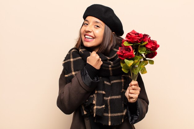 Young pretty woman holding a bouquet of roses