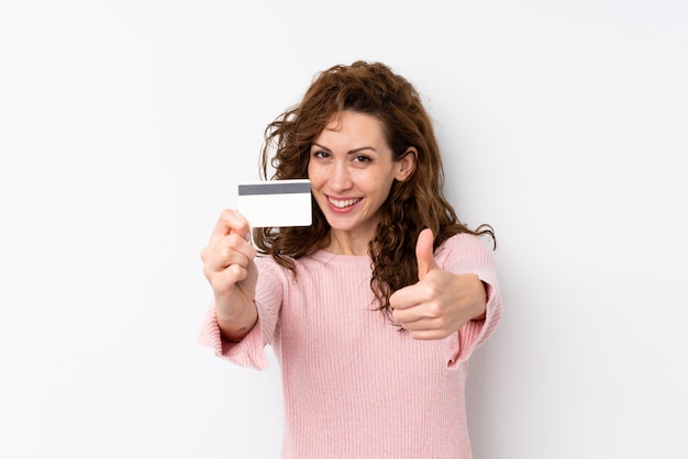 Young pretty woman holding a credit card