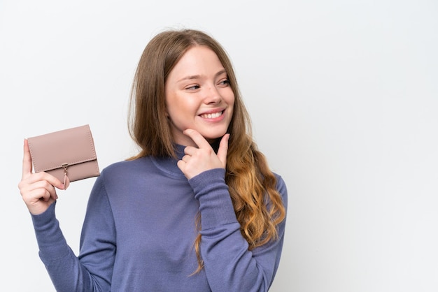 Young pretty woman holding wallet isolated on white background thinking an idea and looking side