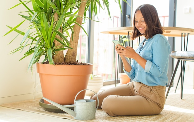 Young pretty woman at home with plants