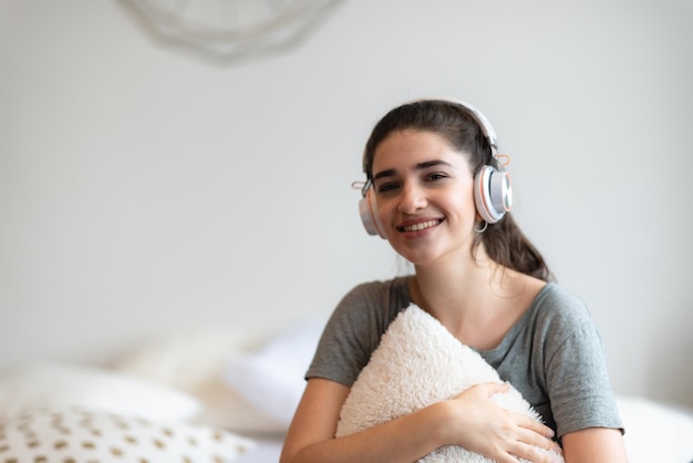 Young pretty woman person are happy and enjoy with music by using earphone for listen a sound audio in bedroom at home relax and fun lifestyle with a song melody house entertainment headset concept