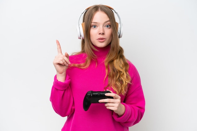 Young pretty woman playing with a video game controller isolated on white background thinking an idea pointing the finger up