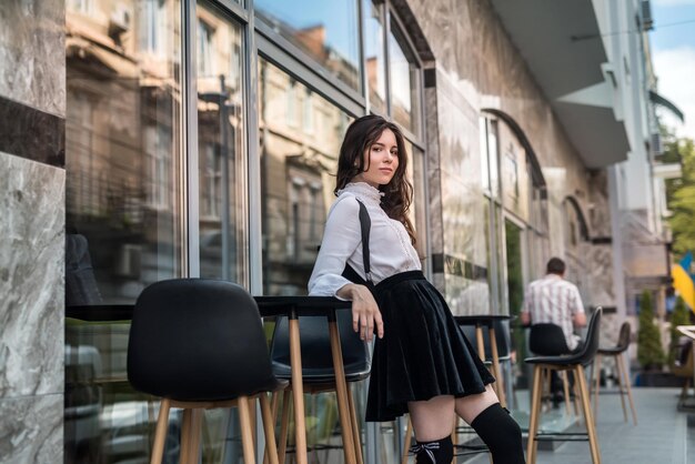 Young pretty woman posing on modern building summer vacation