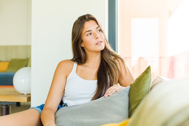 Young pretty woman resting lovely sitting on a sofa