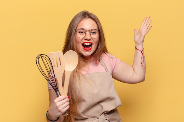 Young pretty woman. shocked or surprised expression chef cooking concept