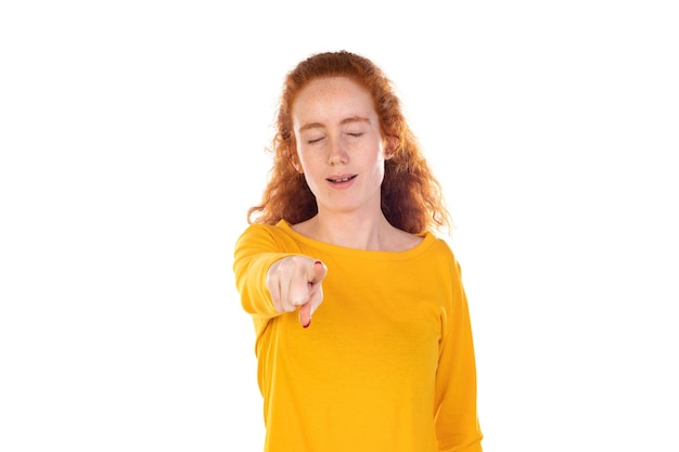 Young pretty woman smiling confidently pointing to something positive relaxed satisfied attitude against white background