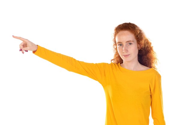 Young pretty woman smiling confidently pointing to something positive relaxed satisfied attitude against white background