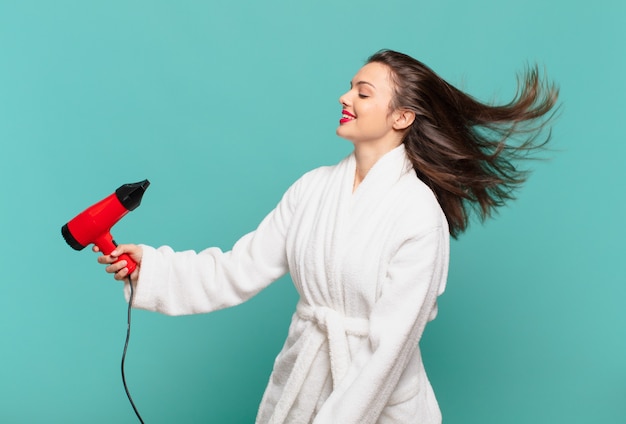 Young pretty woman wearing bathrobe happy expression