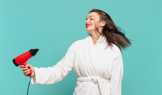 Young pretty woman wearing bathrobe happy expression