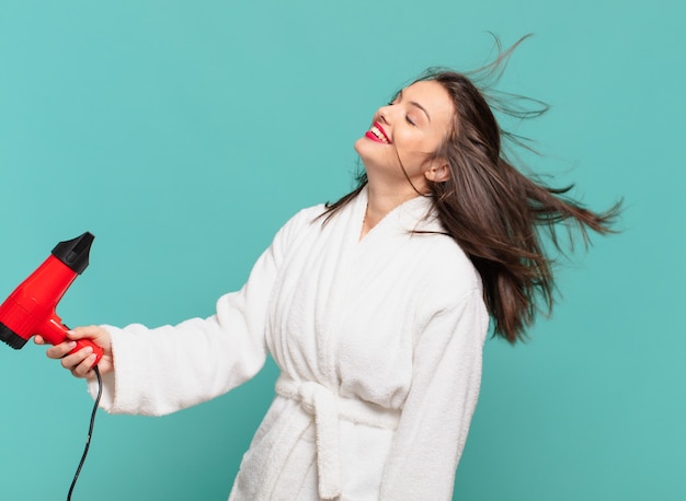 Young pretty woman wearing bathrobe happy expression