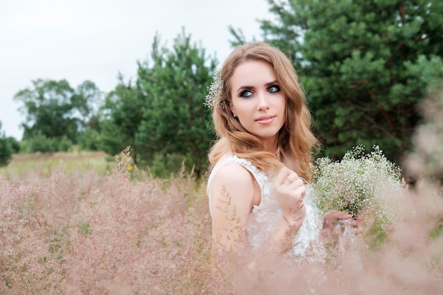 Young pretty woman in white wedding dress