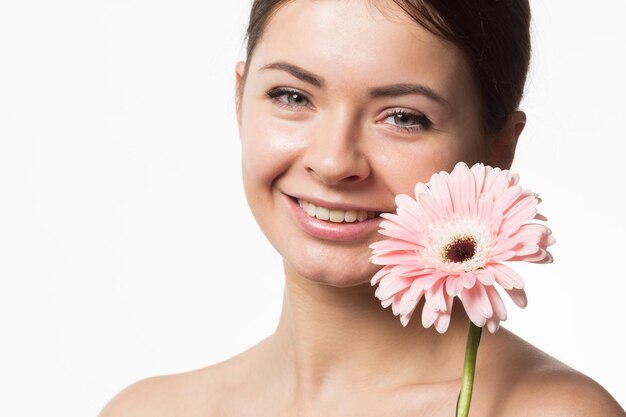 Young pretty woman with flower close up isolated on white hands manicure spa people concept