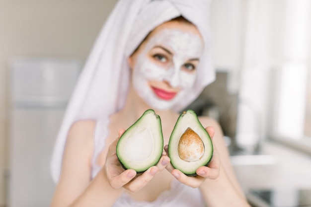 Young pretty woman with head wrapped in towel