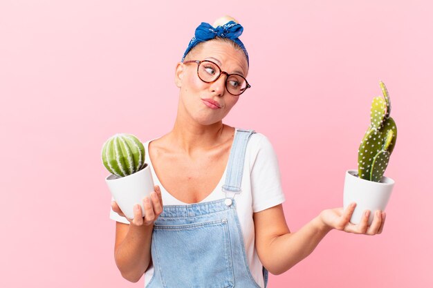 Young pretty woman with a house plant