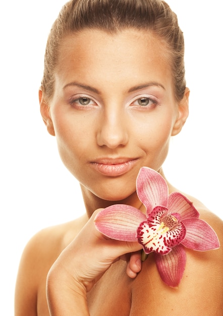 Young pretty woman with pink orchid, isolated on white space, close up picture