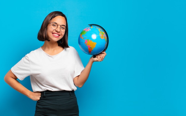 Young pretty woman with a world globe map