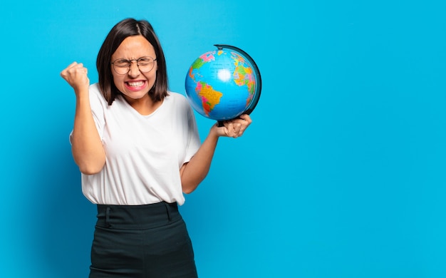 Young pretty woman with a world globe map