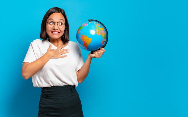 Young pretty woman with a world globe map