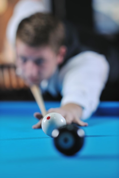 young pro billiard player finding best solution and right angle at billard or snooker pool sport  game