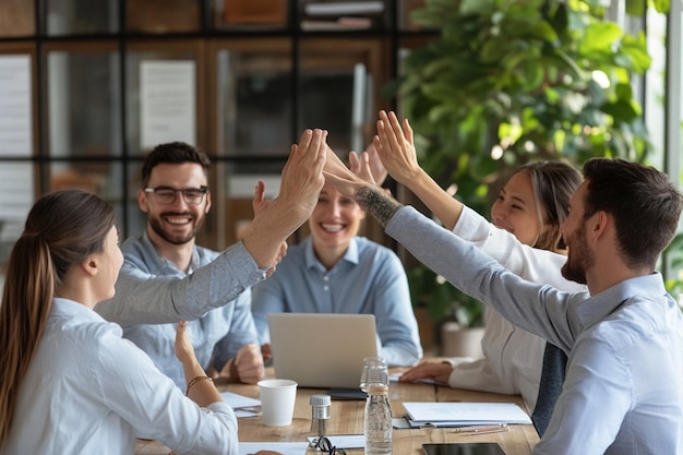 Young professionals highfiving in celebration of a