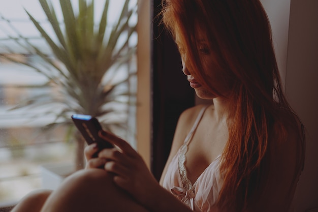 Young red hair woman with cell phone