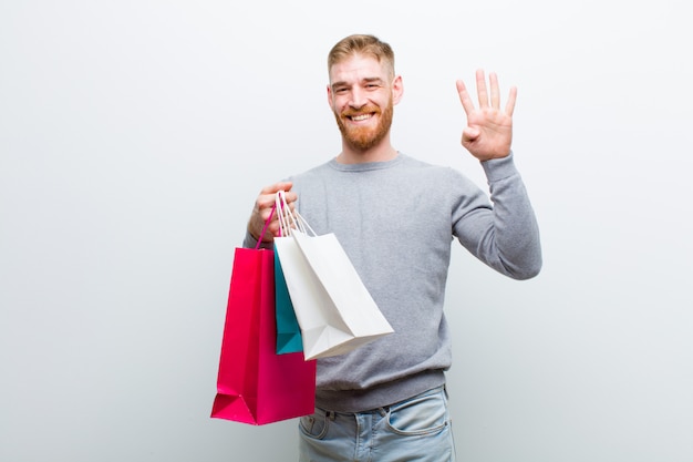 Young red head man with shopping bags